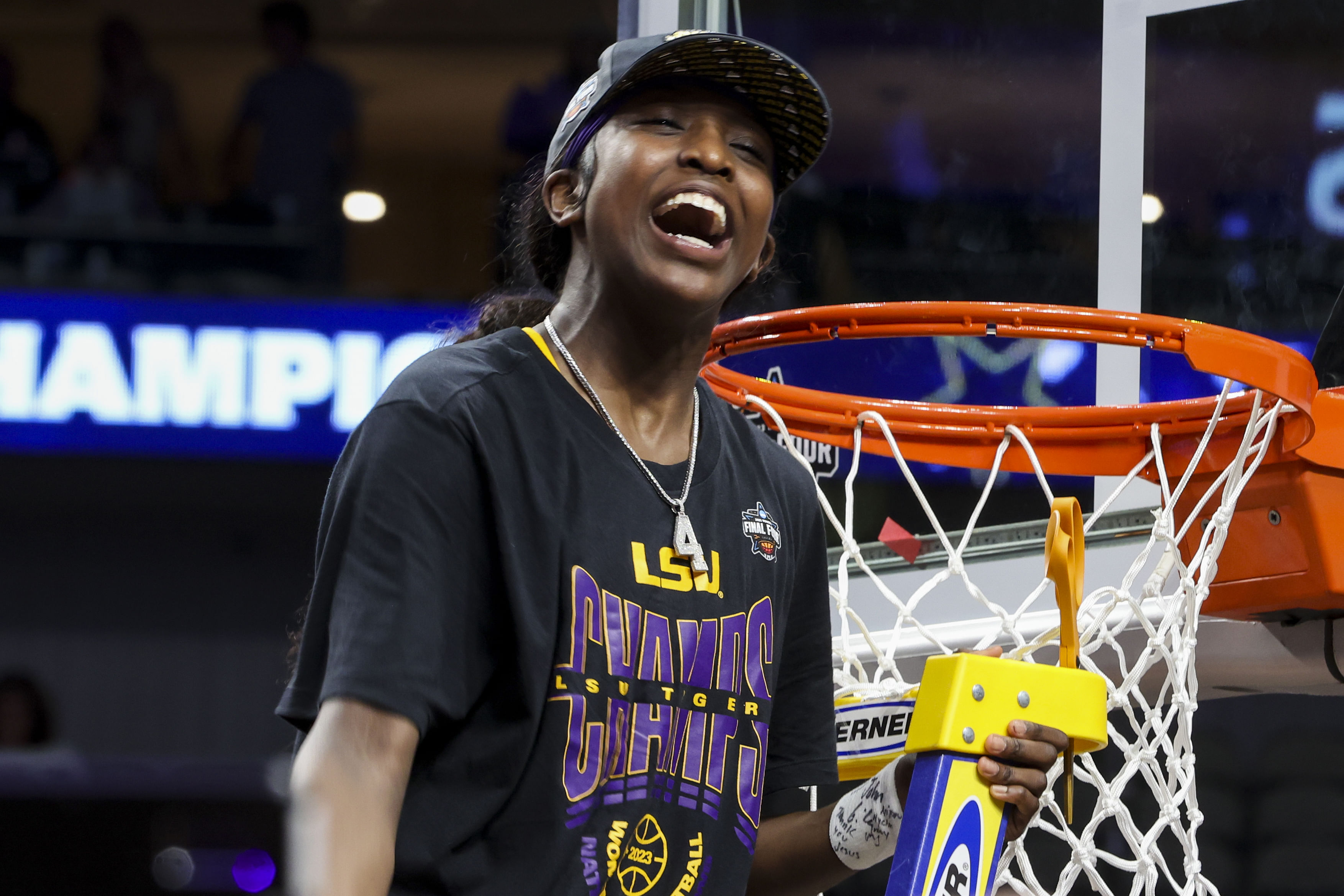 LSU Tigers guard Flau'jae Johnson (4) reacts while cutting down a piece of the net after defeating the Iowa Hawkeyes during the finals of the 2023 NCAA Women's tournament at the American Airlines Center. Photo: Imagn